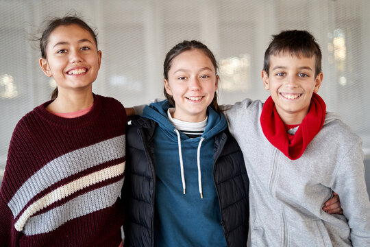 Smiling children pose together indoors at a community center