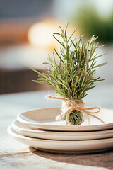 Minimal rosemary bundle on ceramic plates with bright background