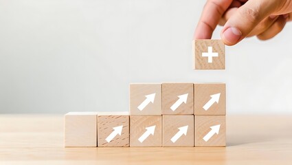 Hand placing wooden block with plus sign on rising arrow blocks wooden blocks growth