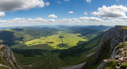 The panoramic expanse of a valley from a mountain ledge.