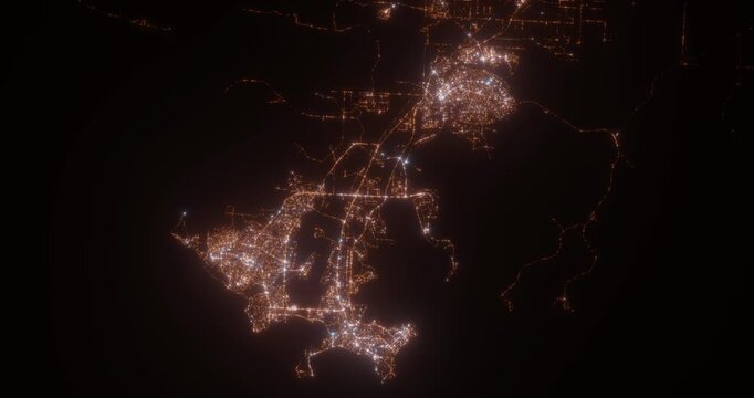Darwin (Australia) aerial view at night. Top view on modern city with street lights. Camera is zooming out, rotating clockwise. Vertical video. The north is on the left side