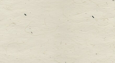 Closeup of textured offwhite paper with small dark flecks
