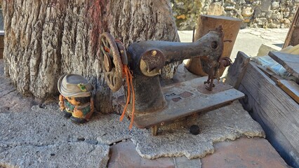 Rustic vintage sewing machine in Asturias, Spain with decorative figurine