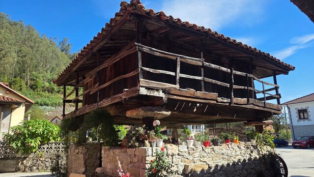 Traditional spanish horreo in Bue&ntilde;o village with rustic architecture under blue sky. Asturias