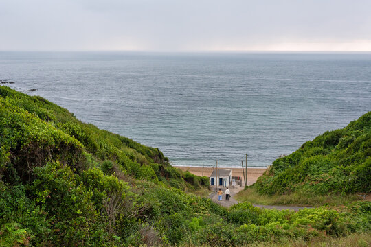 Couple walking down to Lafitenia beach on a gray day. Saint-Jean-de-Luz. Basque-French Piarist Fatherland
