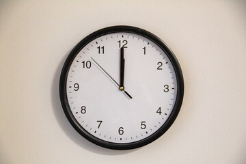 Minimal wall clock showing almost midnight