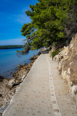 stone steps in a park by the sea, island of Rab, Croatia, Mediterranean, clear, blue sky