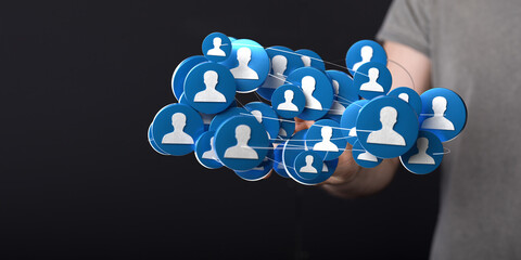 Hand holding digital icons representing a social network or community. A modern concept showcasing connection, networking, and digital presence.
