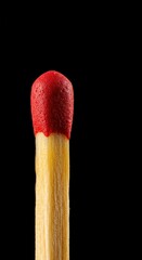 A close-up shot of a matchstick head, its crimson tip poised for ignition, symbolizing readiness and the inherent flammability of common materials ,friction ,combustible material ,light