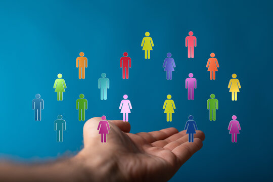 Hand reaching out to hold diverse people icons against blue background. Concept of support community unity teamwork diversity and inclusion.