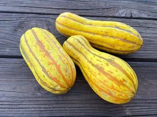 Striped Delicata Squash on Wooden Background