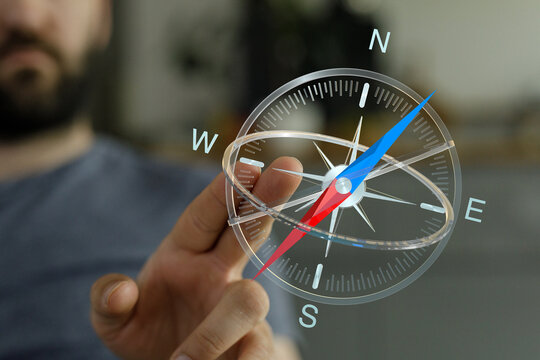 Conceptual image of a hand holding a compass representing direction, guidance, and navigation for travel, business, or decision-making.  Explore