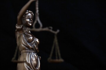 Lady Justice female statue on black backdrop. Law and justice concept