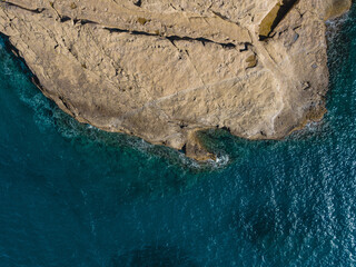 Top-Down View of Turquoise Sea Meeting a Rocky Limestone Coast