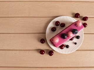 Elegant Pink Glazed Dessert with Berries on Wooden Background