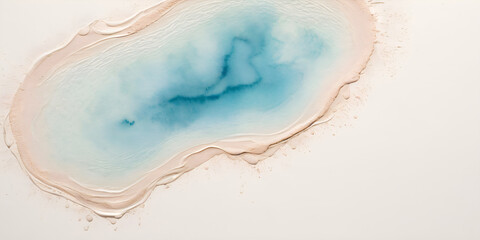 Top-down abstract image of a pale blue water pool on a white and sandy surface