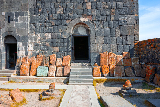 A Sevan Monastery Sevanavank with a large archway and a pile of rocks in front of it