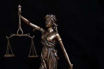 Lady Justice big statue in law on black backdrop. Law and justice concept