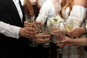 Festive moment as friends raise glasses of champagne, celebrating an important event together in a...