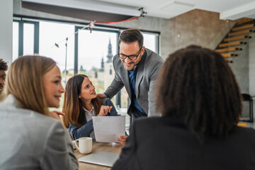 Business professionals collaborating at a meeting in modern office