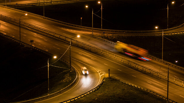vehicle motion captured vividly, nighttime highway scene showing fastmoving freight vehicles