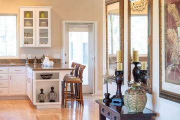 A kitchen with a table, chairs, and a chandelier above