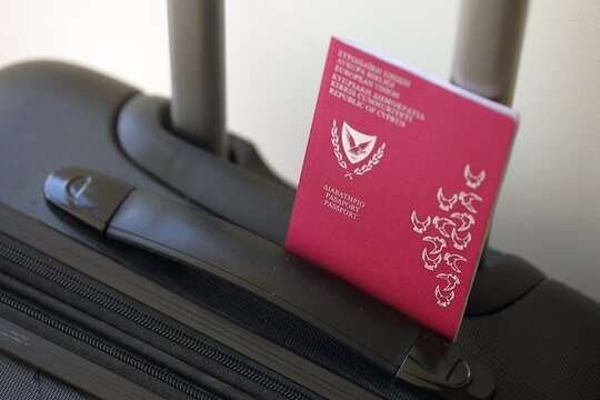 Kyprus passport on touristic baggage luggage in airport close up. Travel and tourism in Europe concept - Powered by Adobe