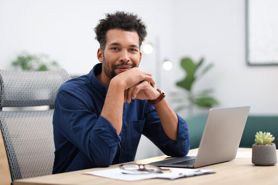 Portrait of man at table in office
