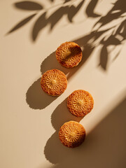 Beautiful cookies with floral patterns on a light surface with shadows