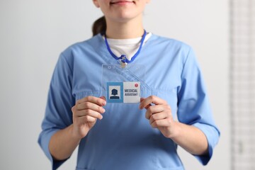 Medical assistant with badge in clinic, closeup