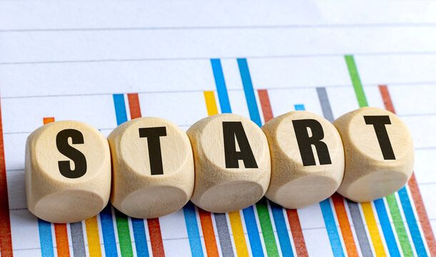 Wooden blocks with text start placed on colorful financial chart background - Powered by Adobe