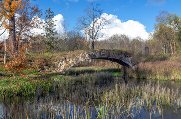 Autumn landscape with a humpback bridge
