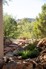 A beautiful stone walkway leading directly into a lush green forest