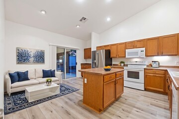 A kitchen that features a large island along with a cozy living room