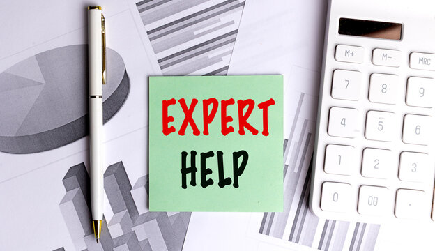 Green card with text expert help on office desk with financial charts, calculator and pen