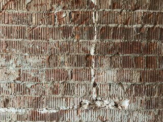 Weathered red brick wall with peeling white plaster, cracks, and subtle discoloration, capturing rustic urban decay and aged architectural texture