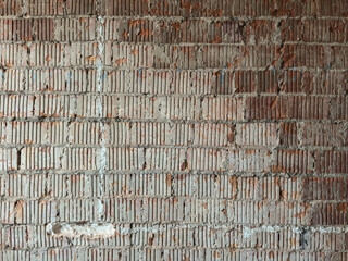 Aged red brick wall with weathered white mortar joints, subtle cracks, and faded patina, embodying...