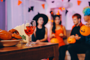 Joyful office Halloween party with coworkers in costumes, celebrating with drinks and laughter, fostering teamwork and festive spirit