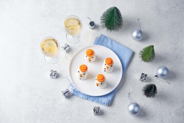 Boiled eggs in the form of snowmans in a plate for Christmas holidays