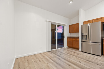 A kitchen with wooden cabinets, stainless steel appliances, and tile
