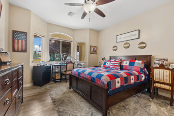 A cozy bedroom featuring a spacious large bed and a cooling ceiling fan