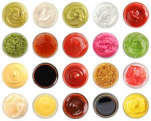 Different condiments isolated in bowls on white, set. Top view