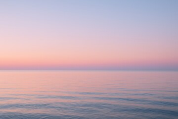 Serene pastel sunrise over calm ocean glassy water and soft clouds peaceful horizon view