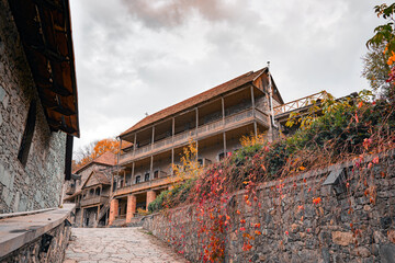 A stone building with a red roof and a stone wall