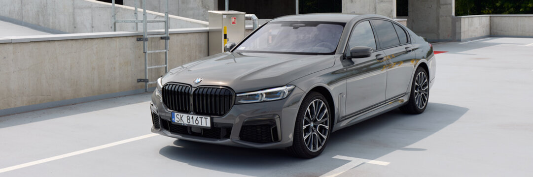 Luxurious gray BMW 740D, G12 model, parked in an empty parking lot. Cloudy day. No other car and people. Katowice, Poland, 12.06.2021