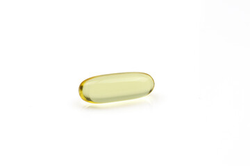 Omega 3 translucent golden pill isolated on white background