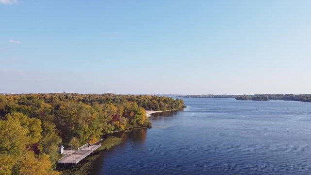 Aerial View of Eastern Europe Autumn Landscape. Drone flight over the Dnipro River and Khortytsia Island in Ukraine. Large wide river, golden forest and rocky coastline.
