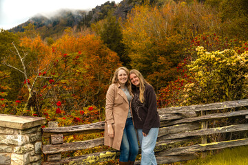 friends enjoying autumn scenery together, candid snapshot of women embracing fall colors