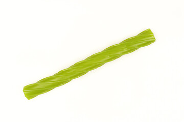 Single green gummy licorice stick isolated on white background. Chewy liquorice treat