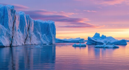 Majestic Icebergs Bathed in the Vibrant Hues of a Sunset Reflected on Tranquil Waters